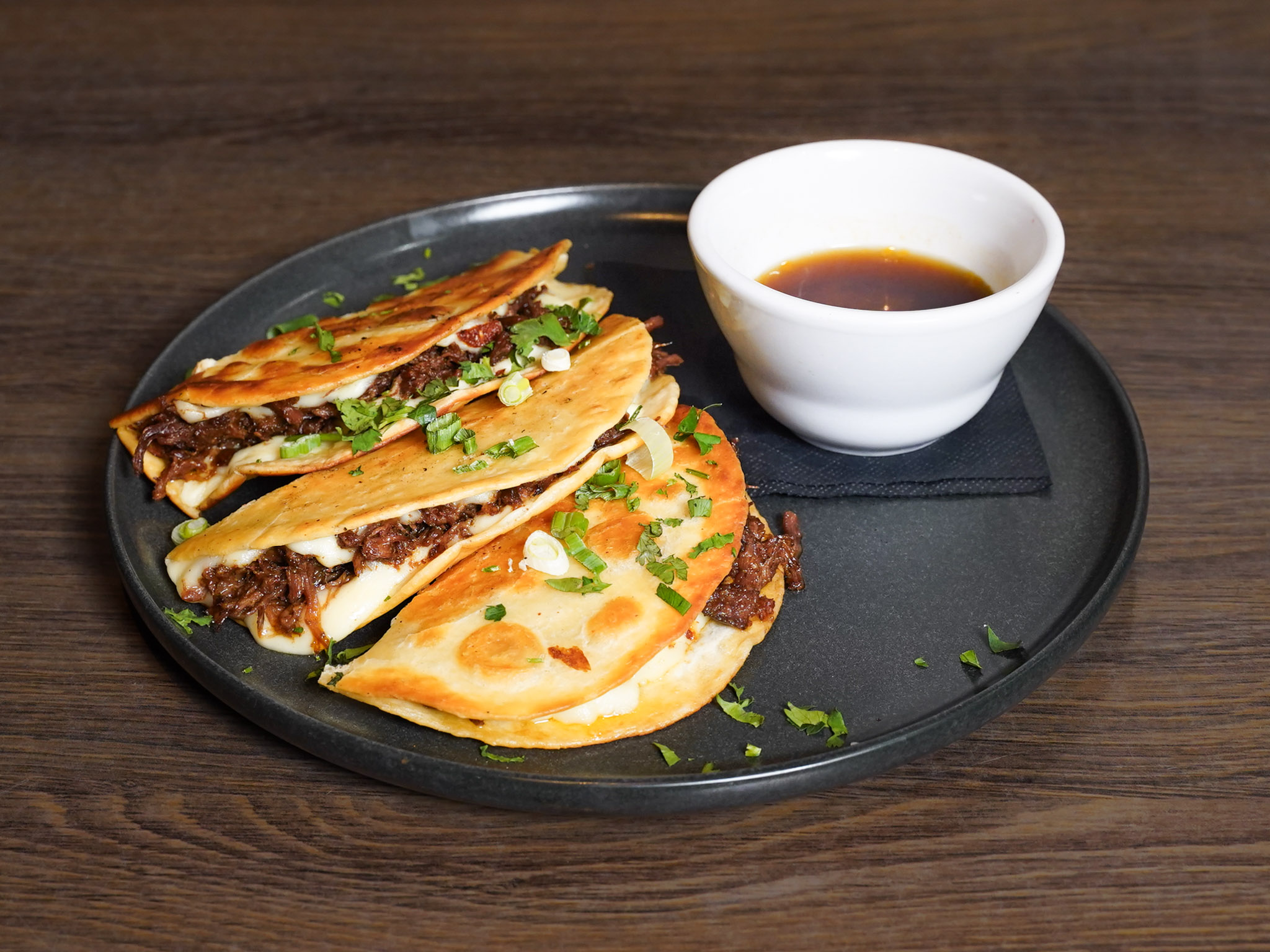Birria Tacos at Pump House Grille Co. — crispy corn tortilla, chipotle beef, mozzarella and consommé, Port Credit